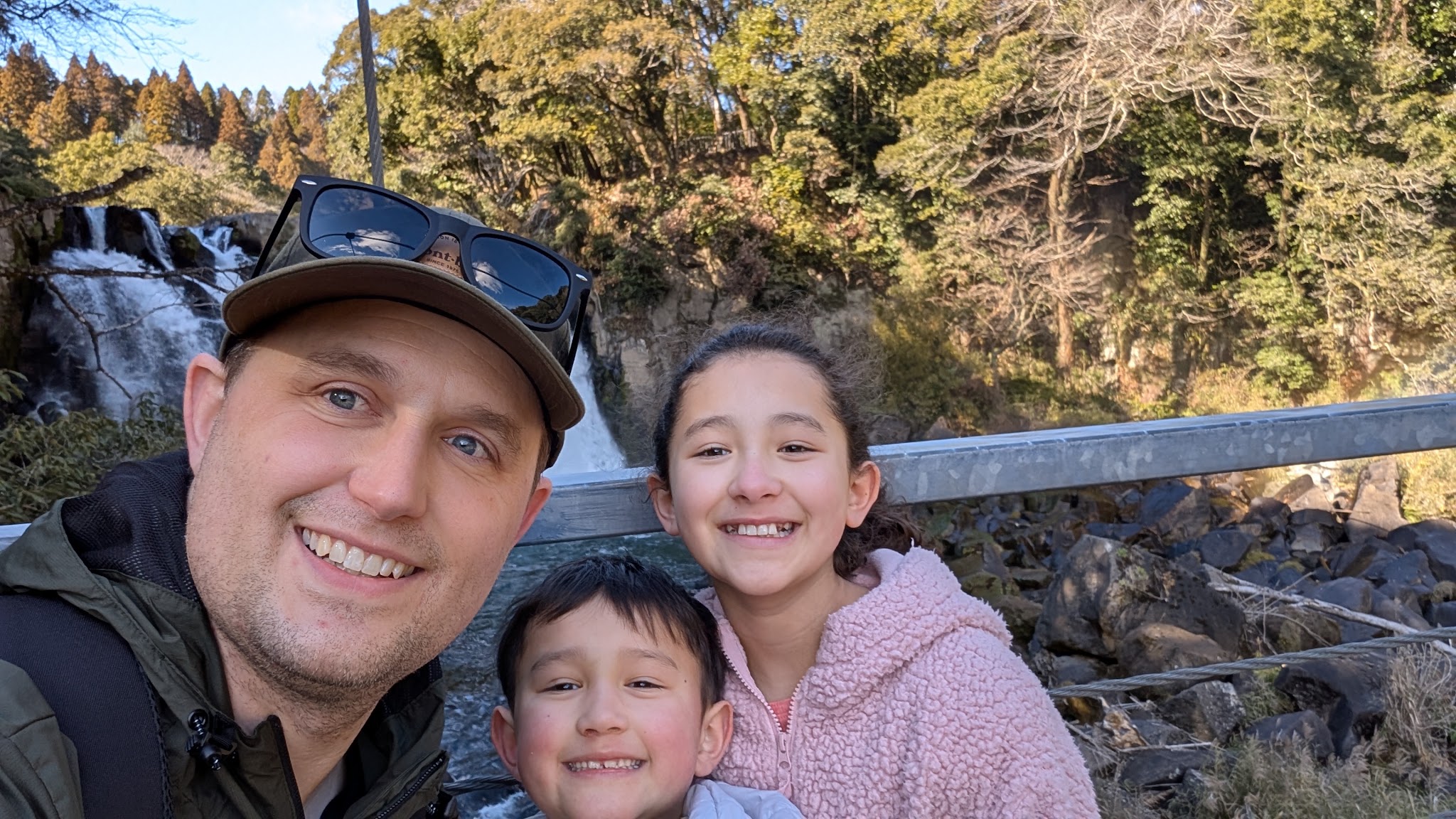 Dr. Baker and his kids at a waterfall in Japan