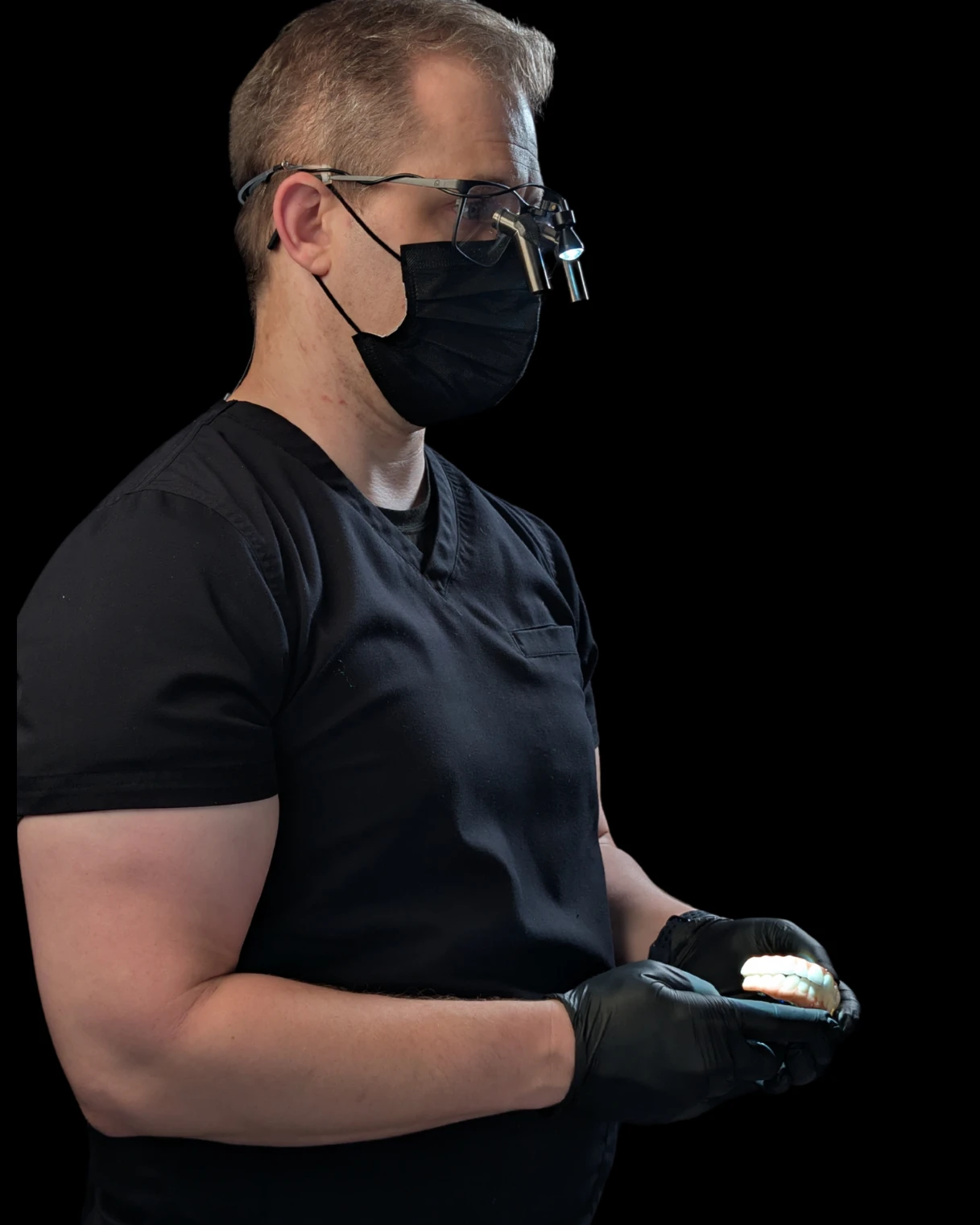 Dr. Baker holding an All-on-X full-arch implant prosthetic